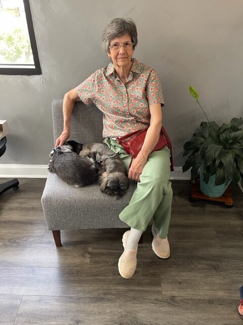 Patient seated with dogs nearby