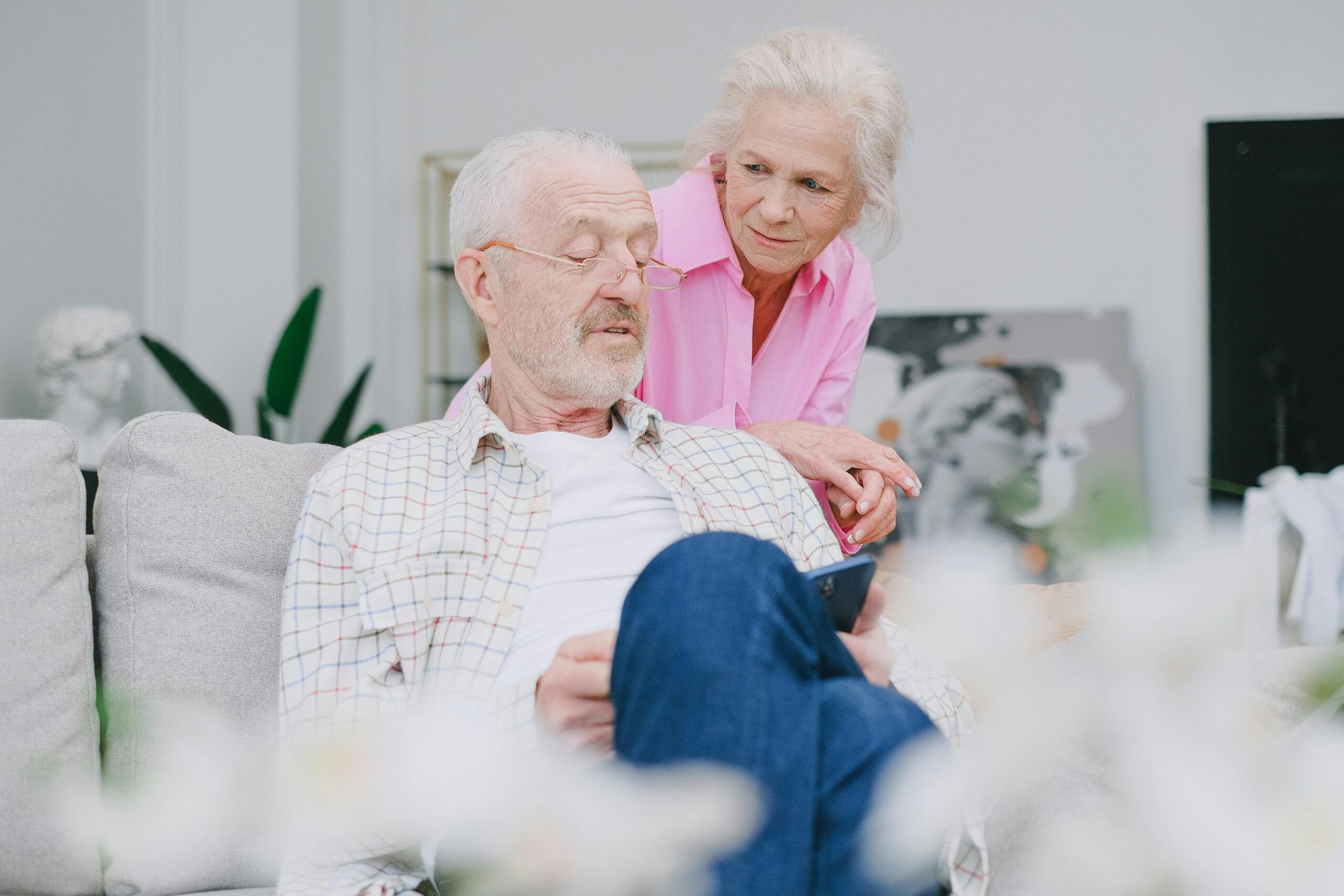 Older couple relaxing at home, managing stress together.