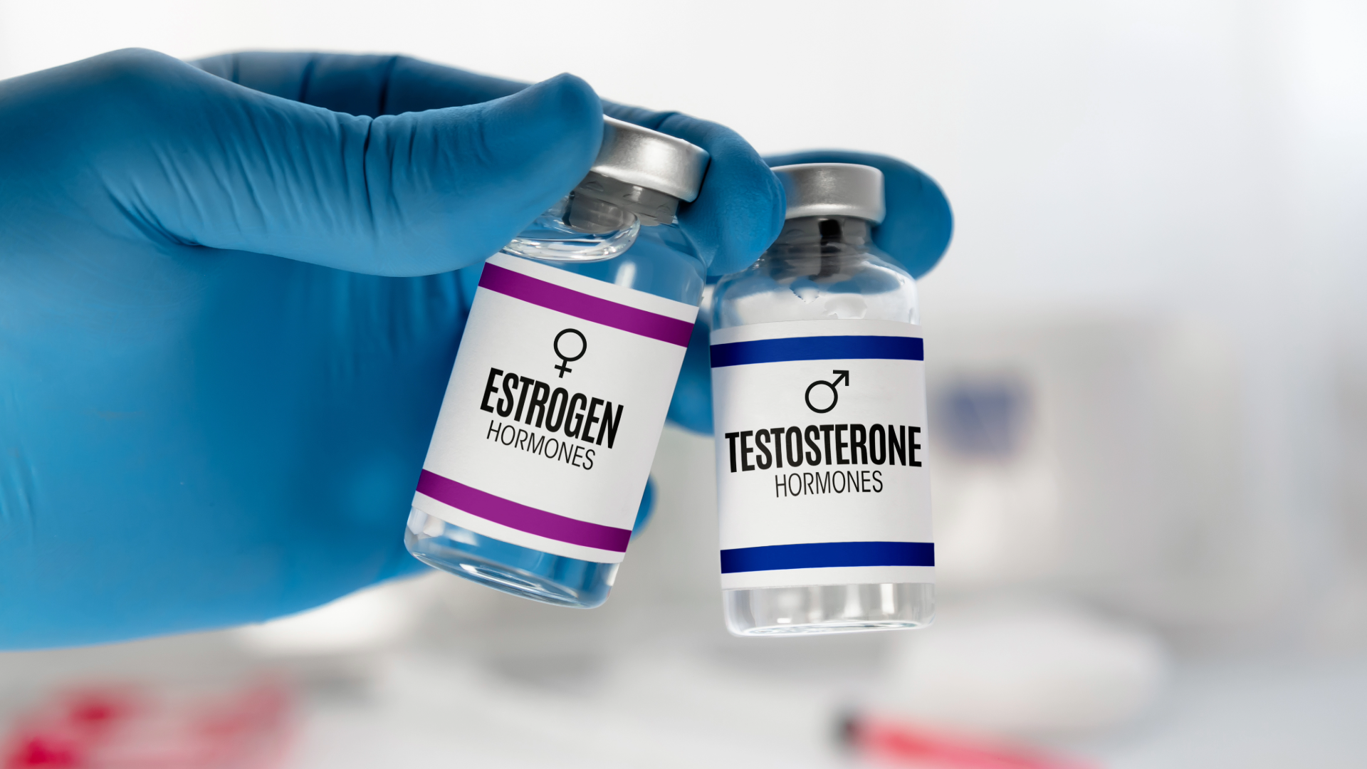 Two vials labeled Estrogen Hormones and Testosterone Hormones, representing hormone therapy treatments for men and women.